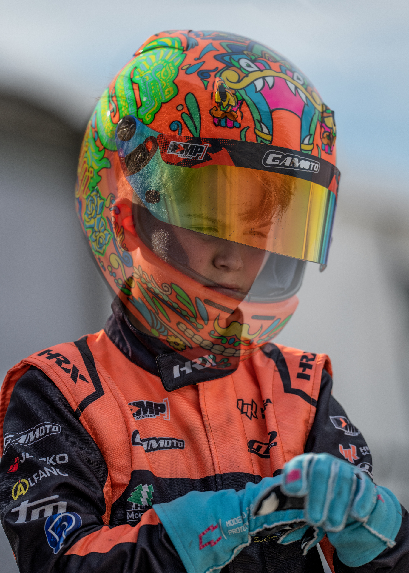 Close portrait of Guido wearing his illustrated racing helmet